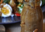 Peanut chilli sauce in a small bottle with drips running down the side